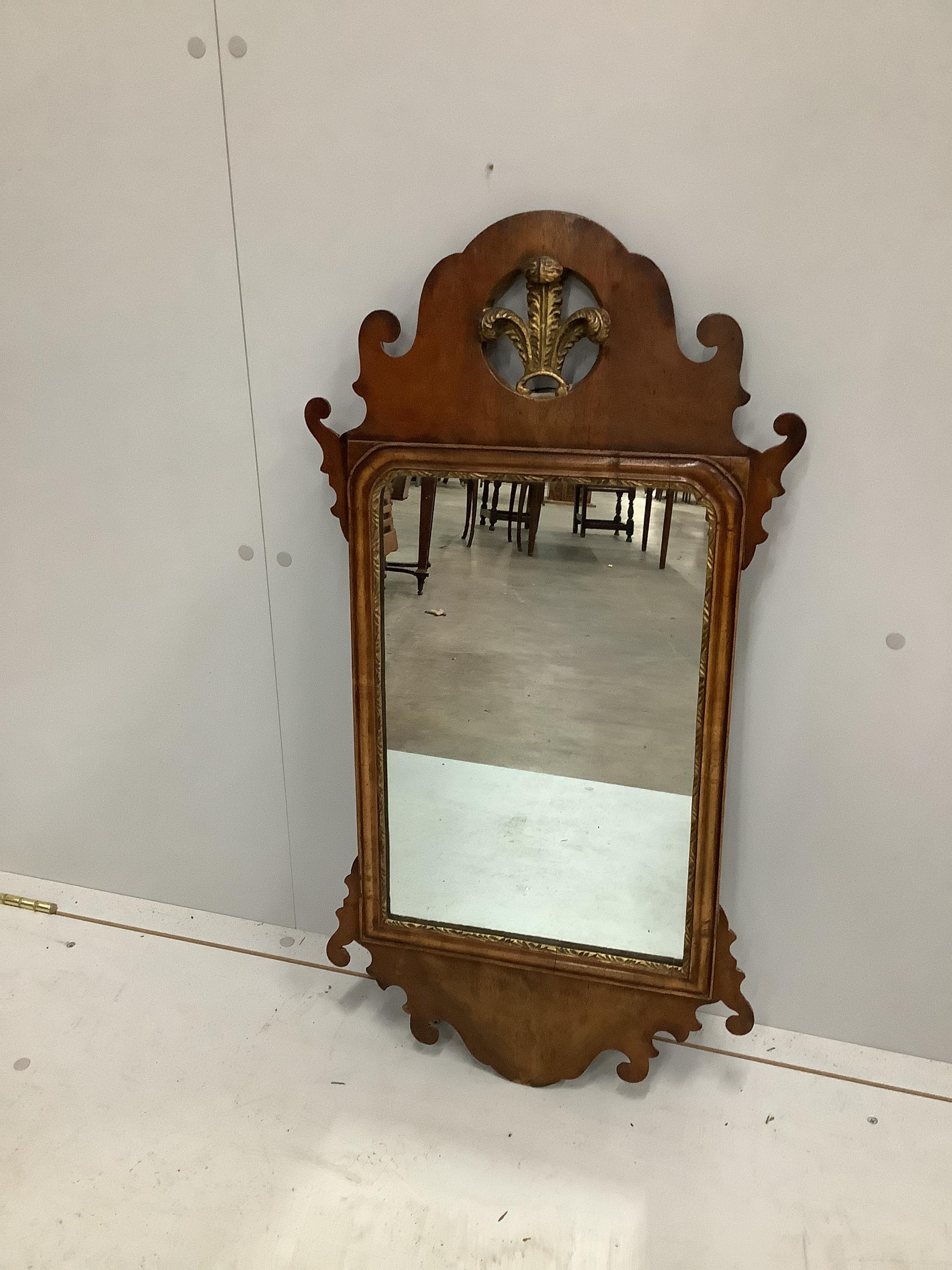 A George III style walnut fret cut wall mirror with Prince of Wales Feathers, width 42cm, height 80cm